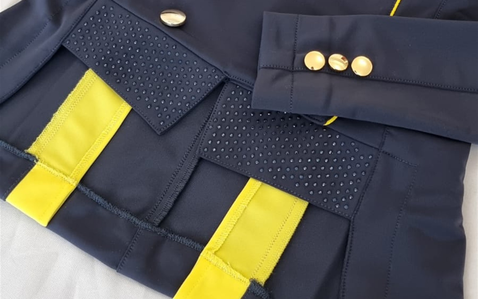 Pocket, waist and lower construction details on a Vainqueur competition jacket